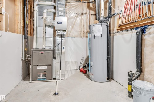 Utility room featuring a furnace, water heater, and PEX manifold system - 1103 29 Street, Edmonton, AB - Indoor Photo Showing Basement