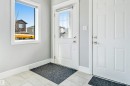 Entryway featuring light gray walls, white trim, and light-toned tile flooring - 1103 29 Street, Edmonton, AB  - Indoor Photo Showing Other Room 