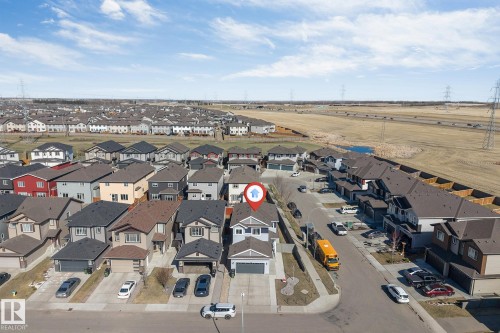 Residential property featuring an attached garage, paved driveway, and established front landscaping - 1103 29 Street, Edmonton, AB - Outdoor With View