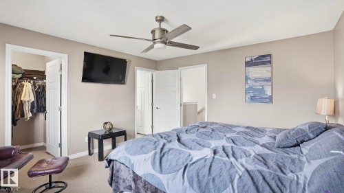 Bedroom featuring neutral wall colors, carpet flooring, a ceiling fan with integrated lighting, and white paneled doors - 1709 64 Street, Edmonton, AB - Indoor Photo Showing Bedroom