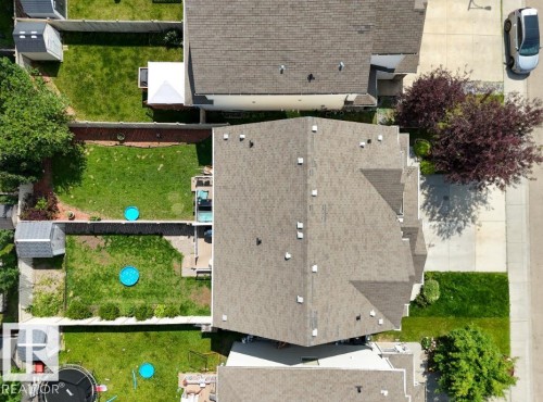 Residential property featuring a shingle roof and surrounding green space - 1709 64 Street Sw, Edmonton, AB - Outdoor