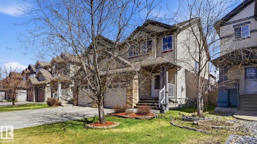 Two-story residence featuring light-colored siding and a stone-clad lower facade - 1709 64 Street, Edmonton, AB - Outdoor With Facade