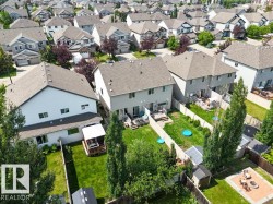 Aerial perspective showcasing a residential neighborhood with numerous detached homes - 
