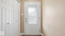 Entryway featuring a white paneled door with frosted glass, brushed nickel hardware, and neutral wall paint - 1709 64 Street, Edmonton, AB  - Indoor Photo Showing Other Room 