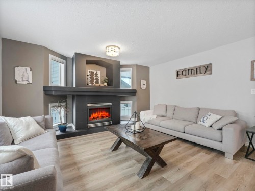 71 Rue Bouchard, Beaumont, AB - Indoor Photo Showing Living Room With Fireplace