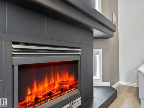 71 Rue Bouchard, Beaumont, AB - Indoor Photo Showing Other Room With Fireplace