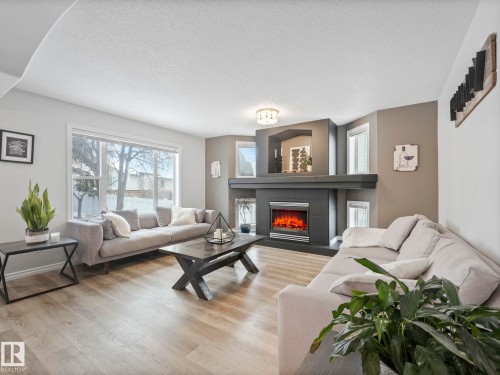 71 Rue Bouchard, Beaumont, AB - Indoor Photo Showing Living Room With Fireplace