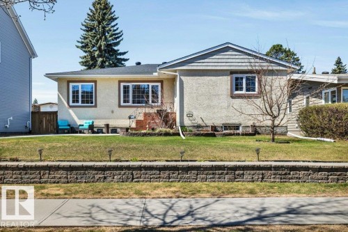 Exterior featuring stucco and shingle siding, a dark roof, and multiple large windows - 10616 136 Street, Edmonton, AB - Outdoor