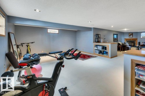 Spacious finished lower level with light gray walls and recessed lighting - 10616 136 Street, Edmonton, AB - Indoor Photo Showing Gym Room
