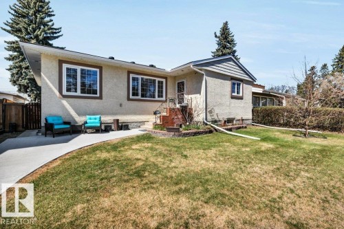 Ranch-style residence featuring a stucco exterior with decorative trim, a concrete walkway, and a landscaped front lawn - 10616 136 Street, Edmonton, AB - Outdoor
