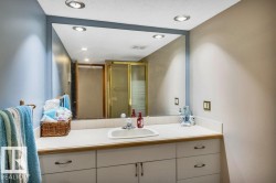 Bathroom vanity with an integrated sink, laminate countertop, and full-width mirror - 