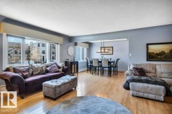 Open concept living and dining area featuring wood-finish flooring - 