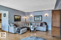 Hardwood flooring extending throughout, complemented by a light gray wall color - 