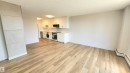 Open-concept living space featuring wood-finish flooring - 603 9028 Jasper Avenue, Edmonton, AB  - Indoor Photo Showing Kitchen 