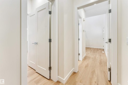 The interior features light-toned flooring, white walls, and white doors with modern hardware - 97 Dansereau Way, Beaumont, AB - Indoor Photo Showing Other Room