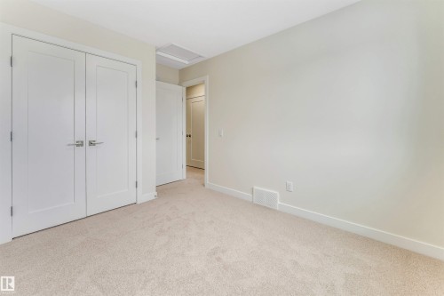 Bedroom featuring light-colored carpeting, white walls, and white trim - 97 Dansereau Way, Beaumont, AB - Indoor Photo Showing Other Room
