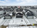 The property features a two-story home with a two-car garage and a paved driveway - 97 Dansereau Way, Beaumont, AB  - Outdoor With Facade 