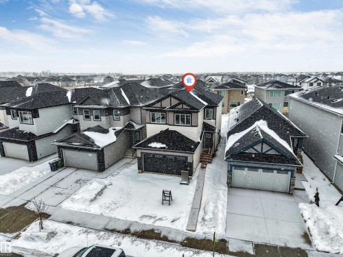 The property features a two-story design with a prominent front entrance and an attached garage - 97 Dansereau Way, Beaumont, AB - Outdoor With Facade