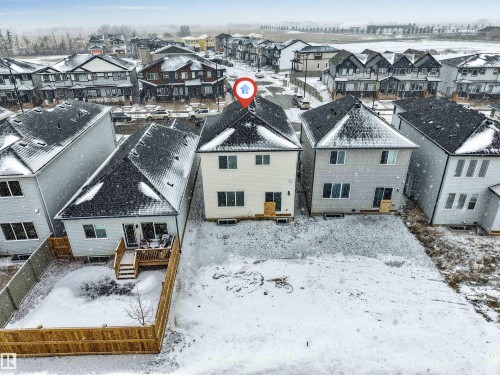 This property features a two-story design with a dark shingled roof and a light-colored exterior - 97 Dansereau Way, Beaumont, AB - Outdoor