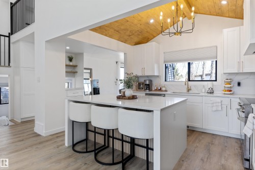 Contemporary kitchen with vaulted wood-plank ceiling, white shaker cabinetry, and a central island featuring a stone-finish countertop - 38 Woodcrest Avenue, St. Albert, AB - Indoor Photo Showing Kitchen With Upgraded Kitchen