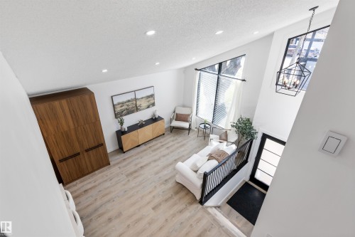 Vaulted ceiling living space with wood-finish flooring - 38 Woodcrest Avenue, St. Albert, AB - Indoor