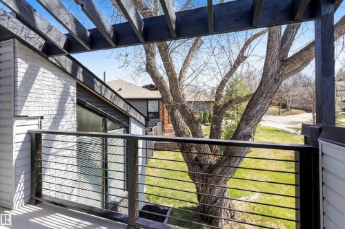 Exterior balcony with black metal railing and overhead pergola structure - 38 Woodcrest Avenue, St. Albert, AB - Outdoor With Exterior