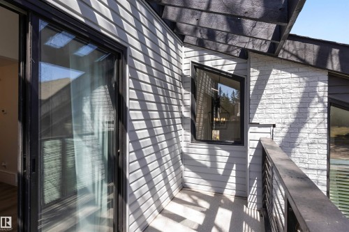 Private balcony featuring horizontal siding, white brick facade, and a dark metal railing - 38 Woodcrest Avenue, St. Albert, AB - Outdoor With Exterior