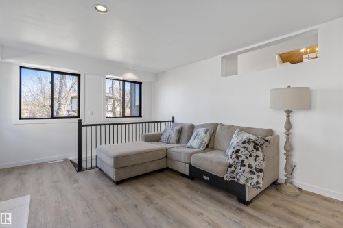 Open-concept space featuring wood-finish flooring, recessed lighting, and white walls - 38 Woodcrest Avenue, St. Albert, AB - Indoor Photo Showing Living Room