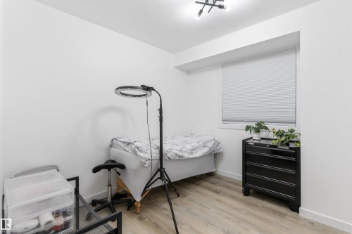 Bright interior space featuring a window with cellular blinds, light wood-finish flooring, and white walls - 38 Woodcrest Avenue, St. Albert, AB - Indoor