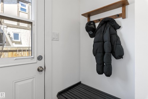 Entryway featuring a white paneled door with glass insert, light-toned walls, and a built-in wooden coat rack with shelf - 38 Woodcrest Avenue, St. Albert, AB - Indoor Photo Showing Other Room