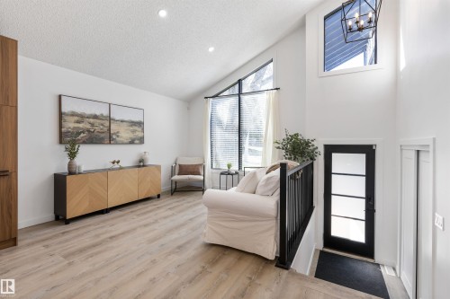 Vaulted ceilings featuring recessed lighting and a contemporary black metal chandelier - 38 Woodcrest Avenue, St. Albert, AB - Indoor