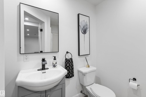 Modern bathroom featuring a contemporary vanity with a white basin and a matte black faucet - 38 Woodcrest Avenue, St. Albert, AB - Indoor Photo Showing Bathroom