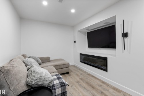Built-in media niche featuring a wall-mounted television and an electric fireplace - 38 Woodcrest Avenue, St. Albert, AB - Indoor Photo Showing Living Room With Fireplace