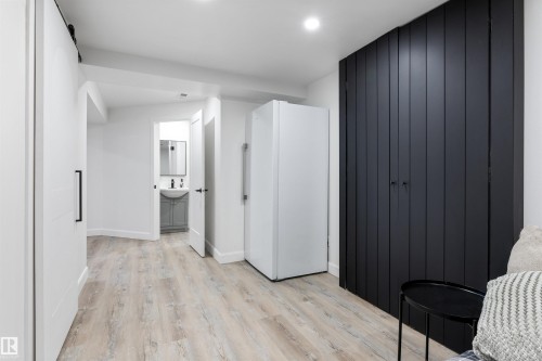 Wood-finish flooring throughout, complemented by a recessed light fixture - 38 Woodcrest Avenue, St. Albert, AB - Indoor Photo Showing Other Room