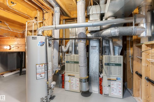 Dedicated utility area featuring a water heater, dual furnaces, and extensive ductwork - 38 Woodcrest Avenue, St. Albert, AB - Indoor Photo Showing Basement