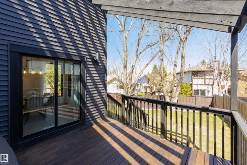 Spacious wood-finish deck with dark railings and pergola, offering an outdoor extension to the interior - 38 Woodcrest Avenue, St. Albert, AB - Outdoor With Balcony With Deck Patio Veranda
