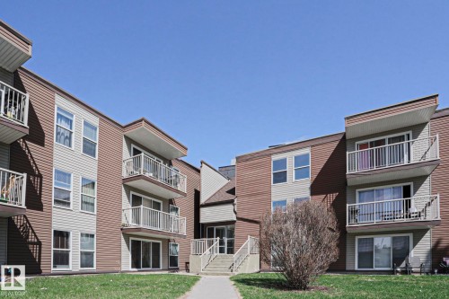 Multi-story building featuring tan and brown horizontal siding - 118 7220 144 Avenue, Edmonton, AB - Outdoor
