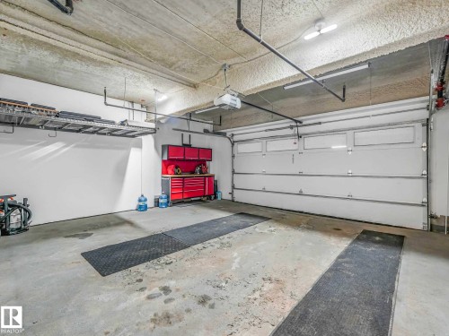 122 5151 Windermere Boulevard, Edmonton, AB - Indoor Photo Showing Garage