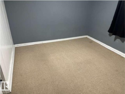 Tan carpeted flooring with white baseboards and dark gray painted walls - 10730 92 Street, Edmonton, AB - Indoor Photo Showing Other Room