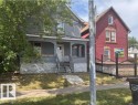 Two-story residence featuring a covered front porch and gray siding - 10730 92 Street, Edmonton, AB  - Outdoor 