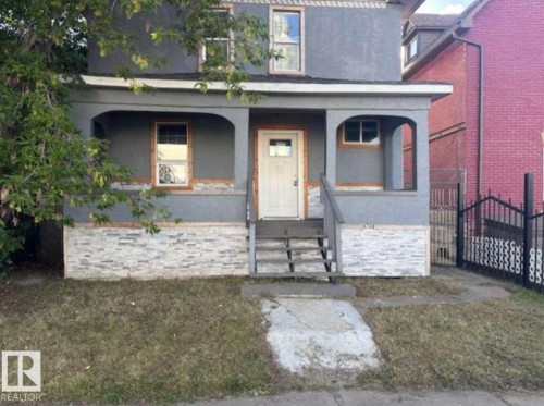 Two-story property featuring a stucco exterior with a stone veneer foundation - 10730 92 Street, Edmonton, AB - Outdoor