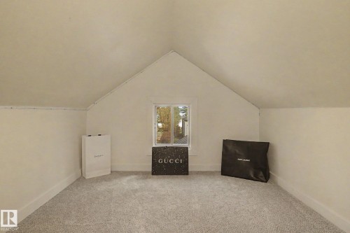 Room featuring neutral carpeting and a central window - 11512 122 St, Edmonton, AB - Indoor