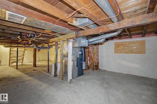 Unfinished basement featuring exposed wood joists, concrete flooring, and visible utility infrastructure including ductwork and piping - 11512 122 St, Edmonton, AB - Indoor Photo Showing Basement