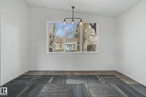 Interior space featuring a white vaulted ceiling and a rectangular window - 11512 122 St, Edmonton, AB - Indoor Photo Showing Other Room