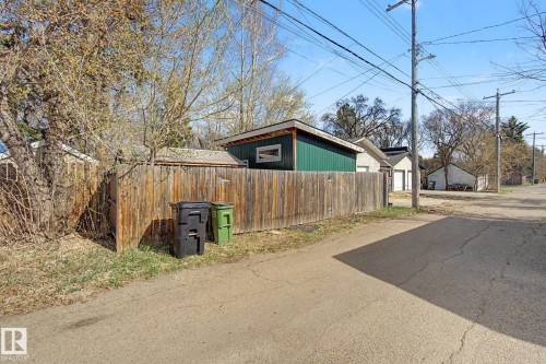 Private wood fencing defines the property perimeter, complemented by mature trees - 11512 122 St, Edmonton, AB - Outdoor