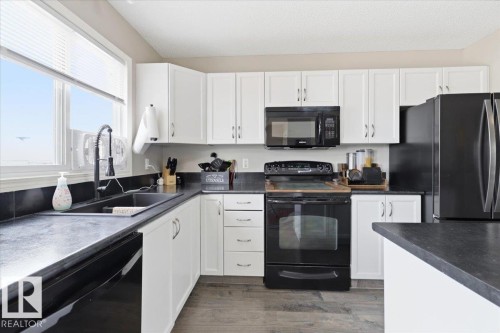 406 Songhurst Place, Leduc, AB - Indoor Photo Showing Kitchen With Double Sink