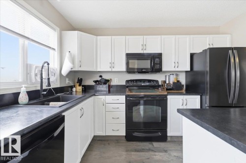406 Songhurst Place, Leduc, AB - Indoor Photo Showing Kitchen With Double Sink