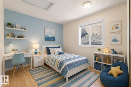 Bedroom featuring wood-finish flooring, a contemporary ceiling light, and a window with white trim - 17313 60 Avenue, Edmonton, AB - Indoor Photo Showing Bedroom