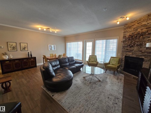 108 11650 79 Avenue, Edmonton, AB - Indoor Photo Showing Living Room With Fireplace