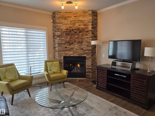 108 11650 79 Avenue, Edmonton, AB - Indoor Photo Showing Living Room With Fireplace